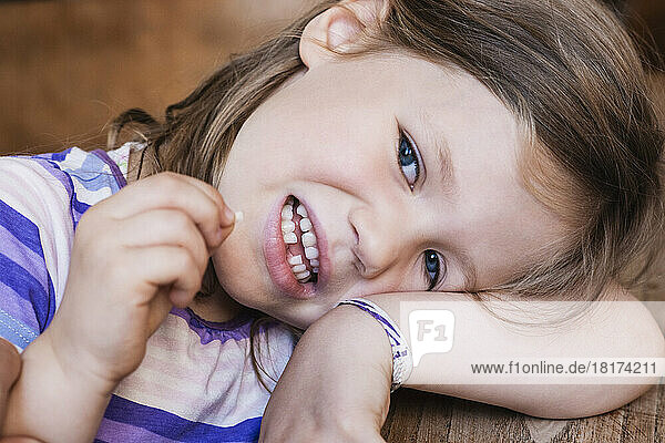 Close-up of Girl Looking at Camera and Holding her Extracted Tooth
