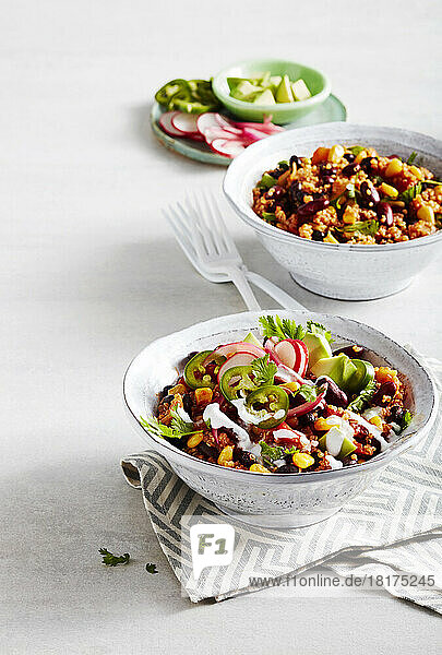 Bowls of vegetable chili with quinoa  beans and corn