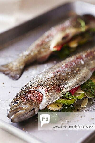 Whole fish stuffed with ginger  lime  chili and garlic on a roasting pan