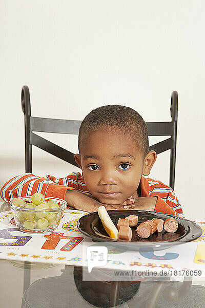 Boy Unhappy with his Lunch at Kitchen Table