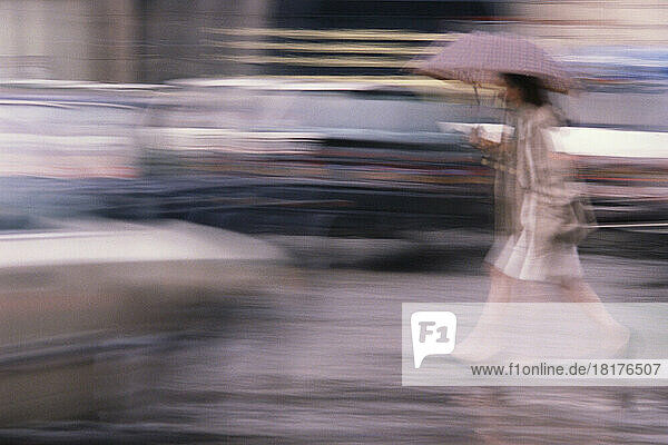 Blurred View of Woman Walking in Rain  Paris  France