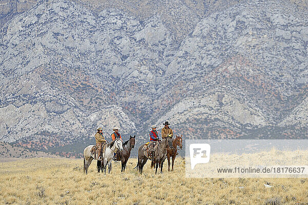 Cowboys and Cowgirls riding horses in wlderness  Rocky Mountains Wyoming  USA