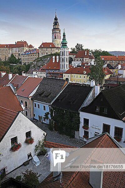 Overview of city and rooftops with the tower of St Jost Church and the tower of Cesky Krumlov Castle in the background  Cesky Krumlov  Czech Replublic.