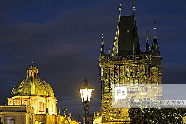 Rooftops of Church of St Francis Seraphinus and the Old Town Bridge Tower at night  Prague  Czech Republic