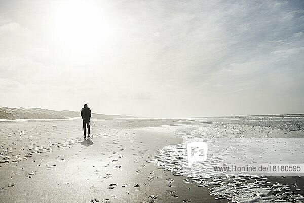 Denmark  Henne Strand  Person walking alone on the beach