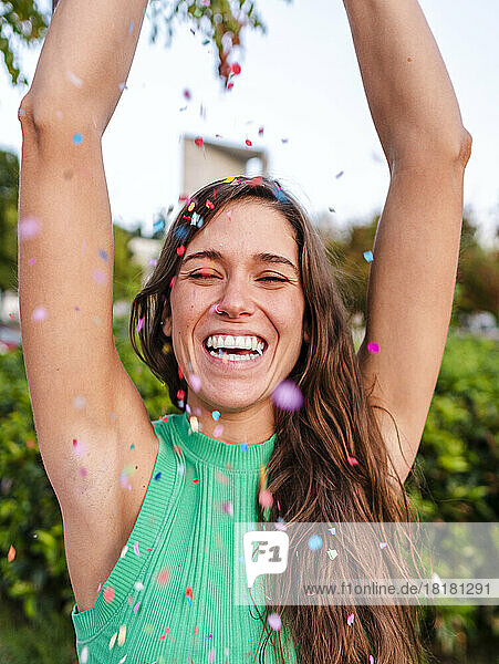 Happy woman having fun with confetti