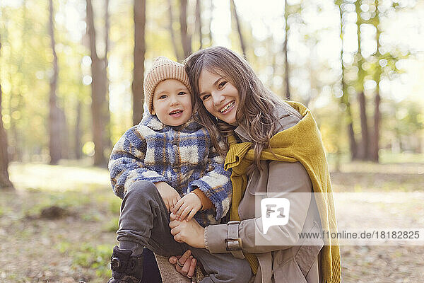 Happy woman with cute son in park