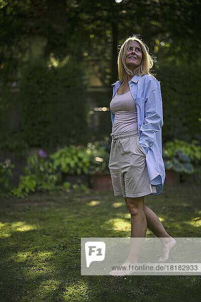 Mature woman with barefoot walking in garden