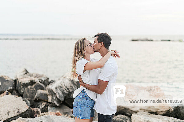 Paar umarmt und küsst sich am Strand