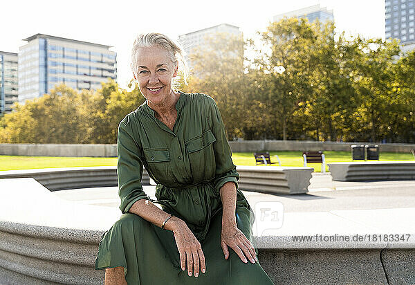 Smiling mature woman on bench in park