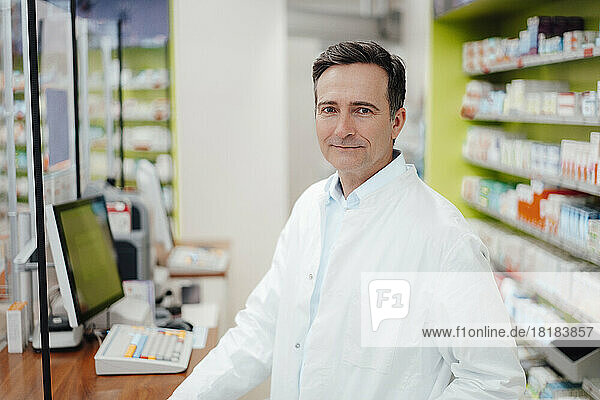 Smiling mature pharmacist in pharmacy