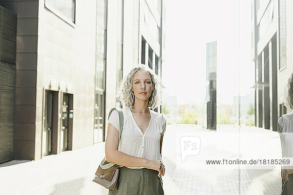 Businesswoman with gray hair on sunny day