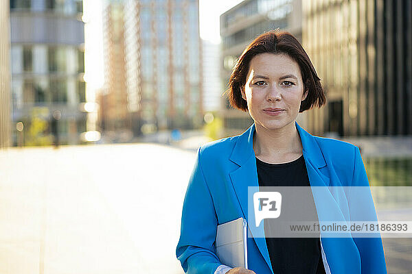 Young businesswoman with short hair holding tablet PC