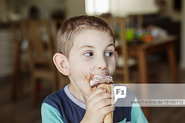 Boy eating ice cream at home