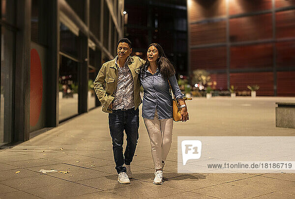 Mature couple walking on footpath at night