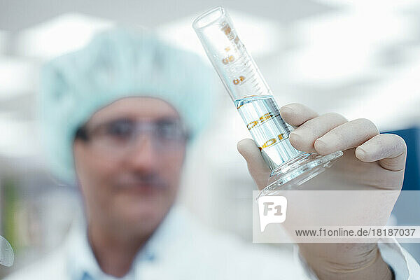 Chemist holding test tube in laboratory