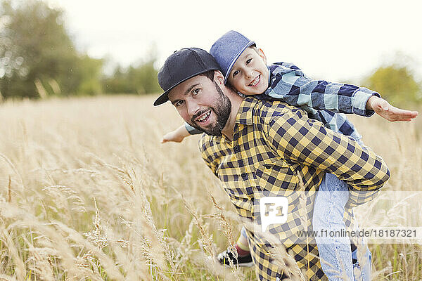 Father and son having fun at field