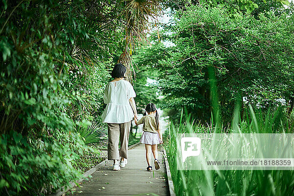 Japanese kid with her mother at city park