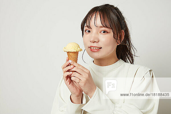 Young Japanese woman eating ice cream