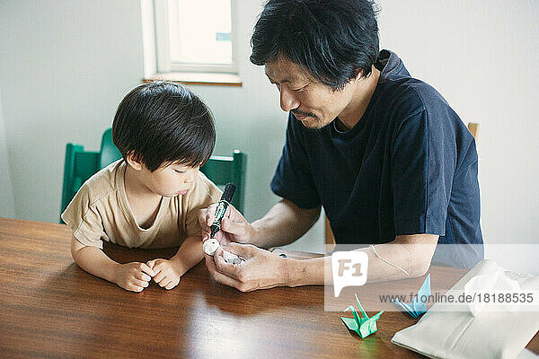 Japanese kid playing with his dad at home