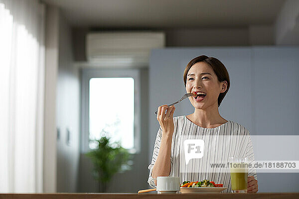 Japanese woman eating at home