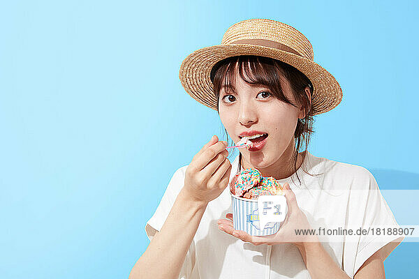 Young Japanese woman eating ice cream