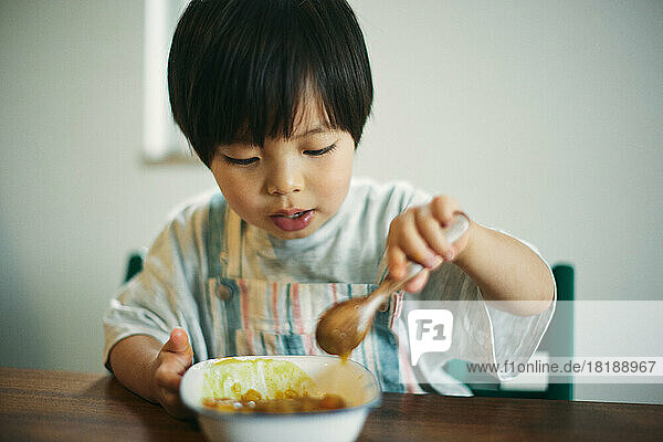 Japanese kid at eating at home