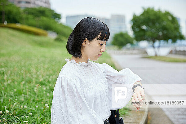 Young Japanese woman at city park