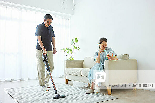 Japanese senior man cleaning at home