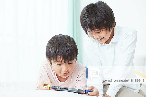 Japanese kids playing games at home