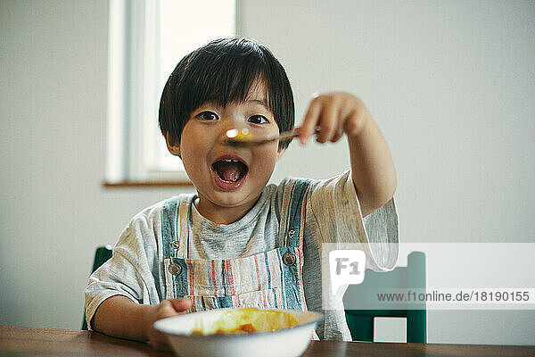 Japanese kid at eating at home
