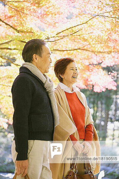 Senior couple traveling during the autumn leaves season
