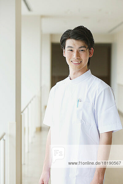 Smiling young male nurse in the hallway