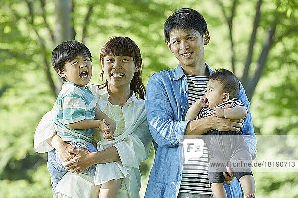 Fresh greenery and smiling Japanese family