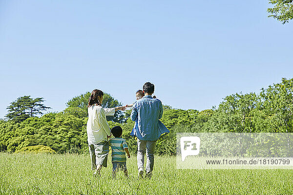 Japanese family walking in the field