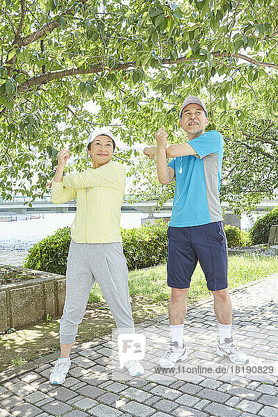 Japanese senior couple doing warm up exercises