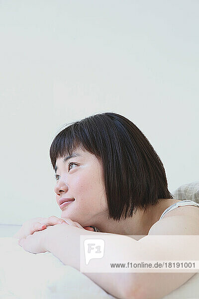 Young Japanese woman relaxing on the bed