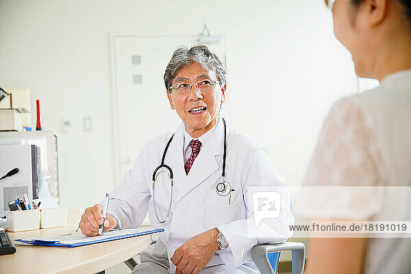 Japanese woman being examined by a doctor