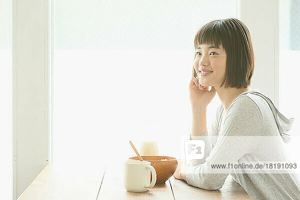 Young Japanese woman having her breakfast