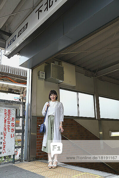 Young Japanese woman exiting the train station