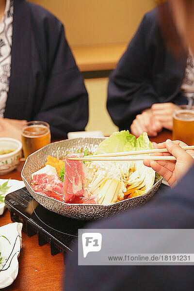 Japanese woman having dinner at a hot spring inn