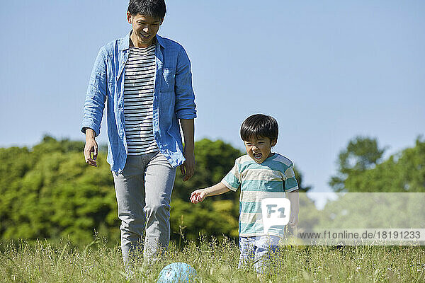 Japanese parent and child playing with a ball