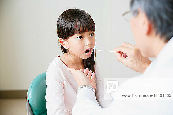 Japanese girl being examined by a doctor