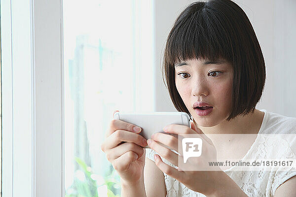 Young Japanese woman looking at mobile phone