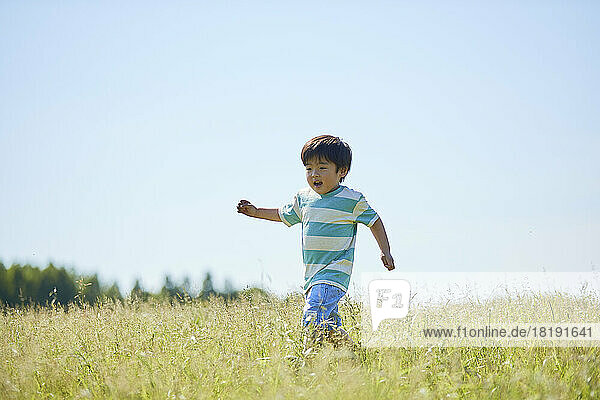Japanese boy running in the field