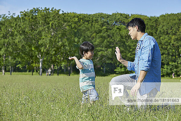 Japanese parent and child giving a high five