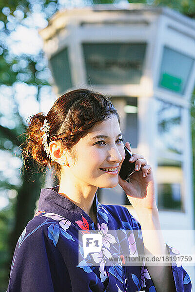 Japanese woman in a yukata making a phone call