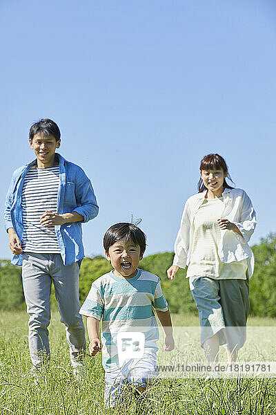 Japanese family running in the field
