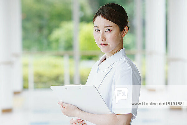 Young Japanese female nurse in the hallway