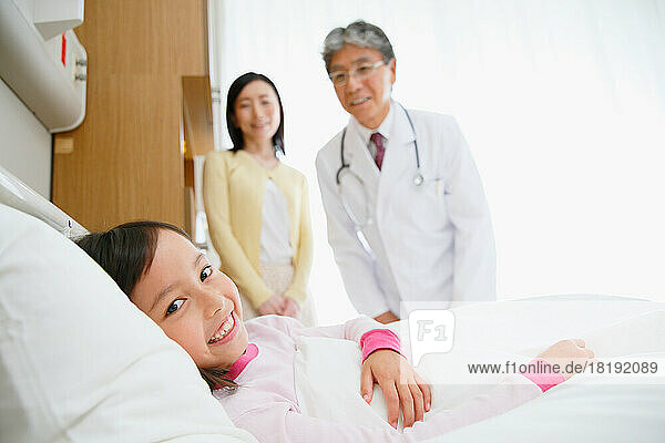 Japanese girl being examined by a doctor in a hospital room